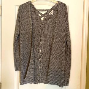Very soft with shimmer sweater.  Braided material down the back